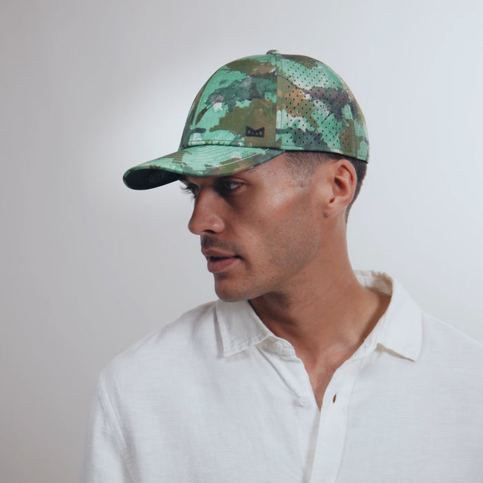 The model-image view of the melin Vintage Fit A-Game Icon Hydro hat in watercolor camo