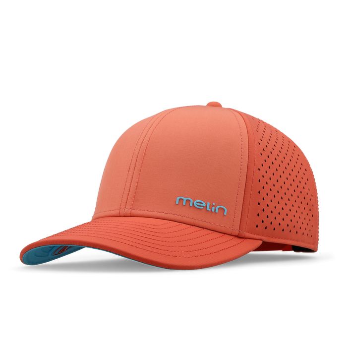 Hot coral baseball cap with perforated back panel, teal undervisor, and "melin" logo on front.