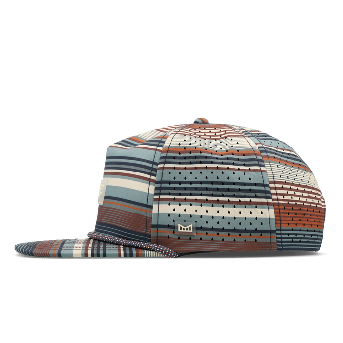 The side view of the melin Split Crushed Fit Coronado Brick Hydro hat in Picante