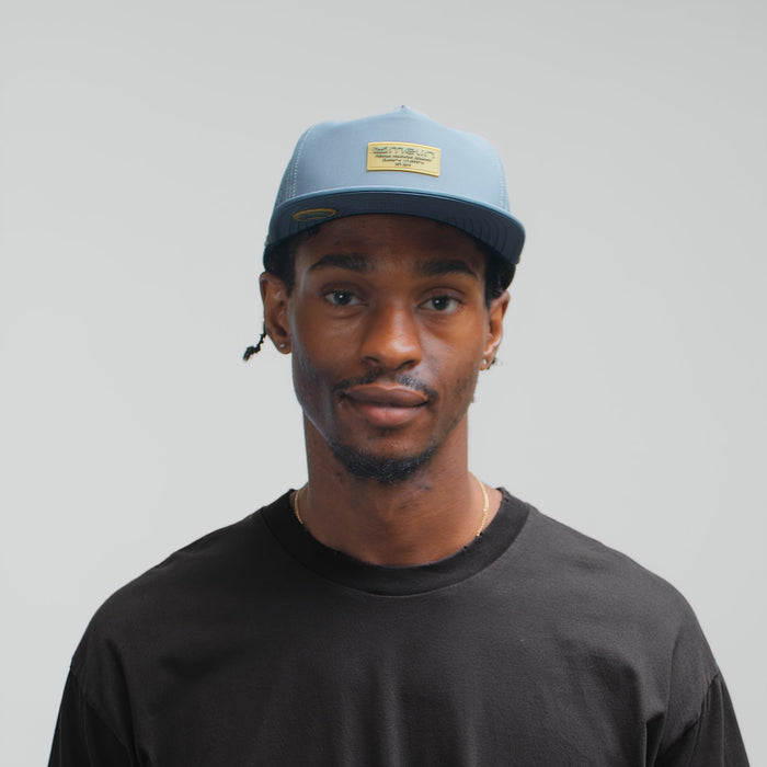 The model-image of the Split Crushed Fit Coronado Brick Hydro Hat in Blue Stone Gum