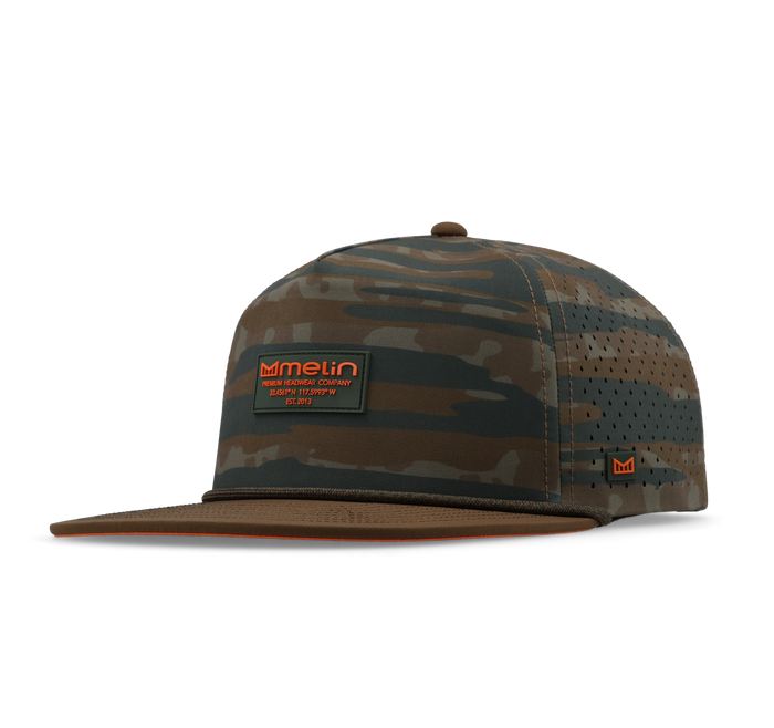 Brown and tan camouflage baseball cap with perforated mesh panels and front logo patch.