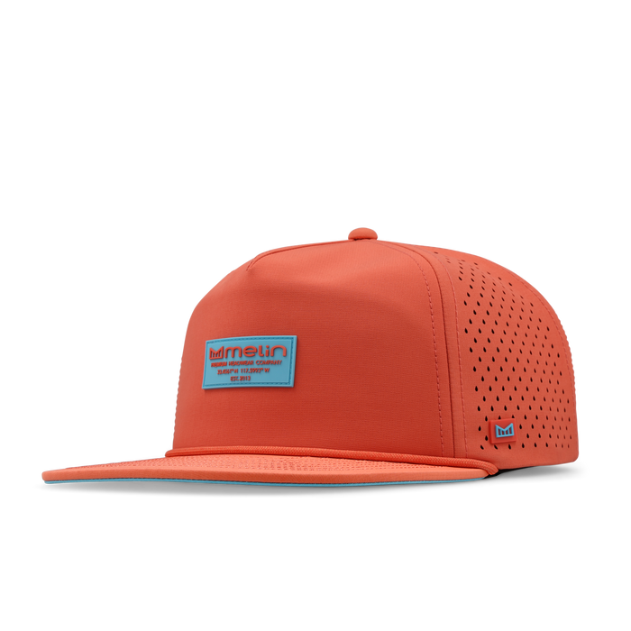 Hot coral snapback cap with perforated side panels, blue logo patch on front, and small embroidered logo on side.