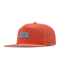 Hot coral snapback cap with perforated side panels, blue logo patch on front, and small embroidered logo on side.