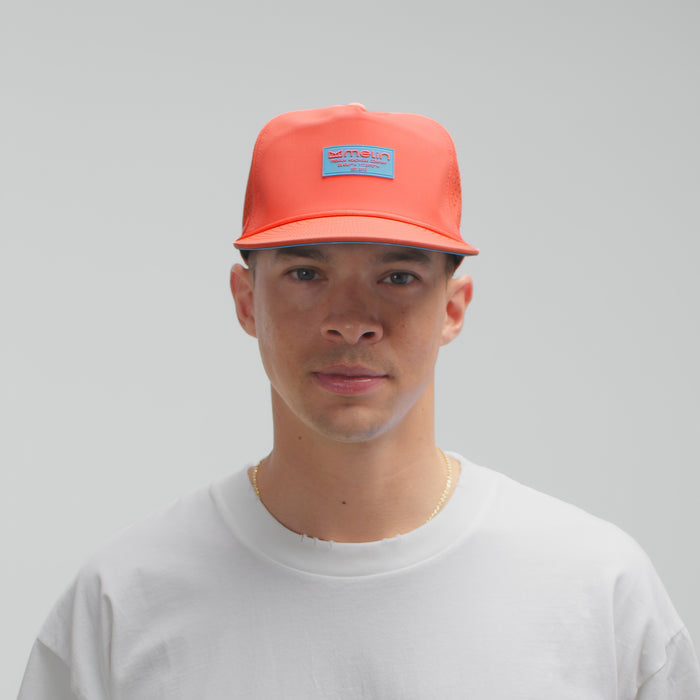 The model-image view of the melin Split Crushed Fit Coronado Brick Hydro hat in Hot Coral
