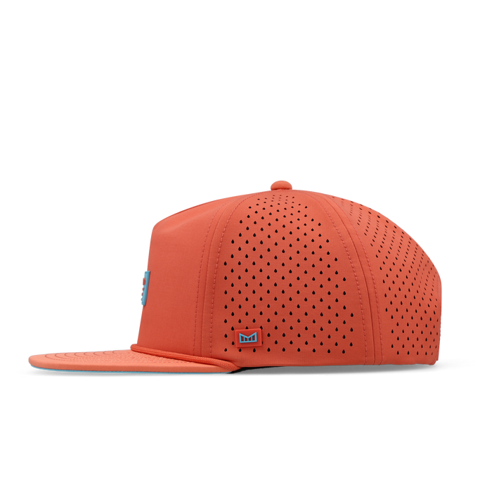 Hot coral snapback cap with perforated vents on crown and back, blue logo badge on side.
