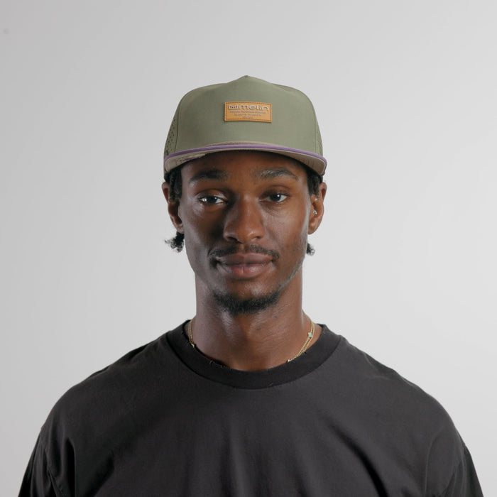 The model-image of the melin Split Crushed Fit Coronado Brick Hydro hat in transit
