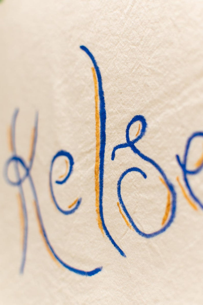 Close-up of hand-lettered name in blue script