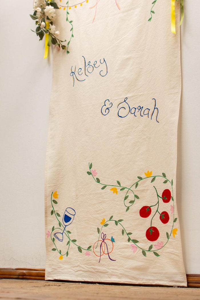 Full banner with names, wine glass, tomatoes and flowers