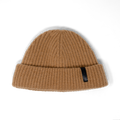 Khaki ribbed knit beanie with a small black label on the cuff.