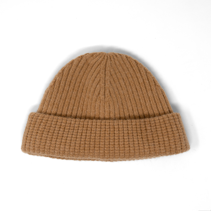 Khaki ribbed knit beanie with folded cuff displayed against white background.