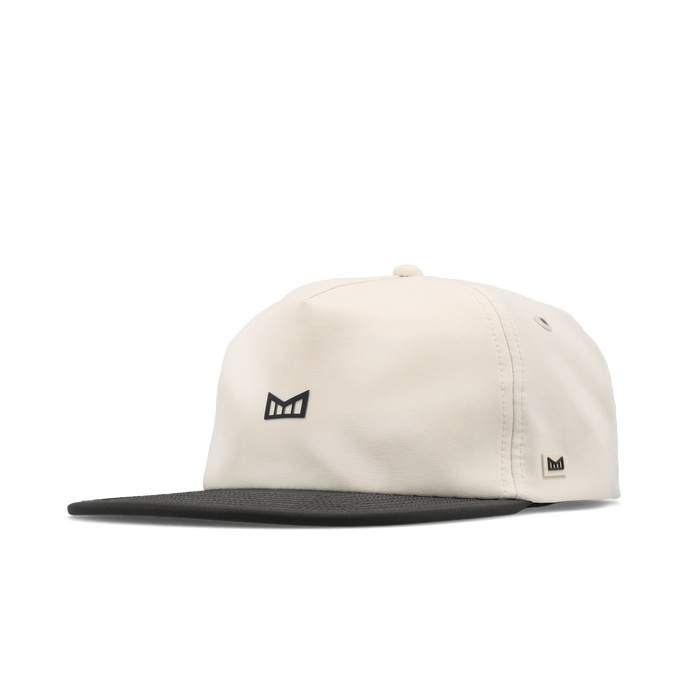The angled view of the melin Split Crushed Fit Eagle Hydro hat in moonbeam / pirate black