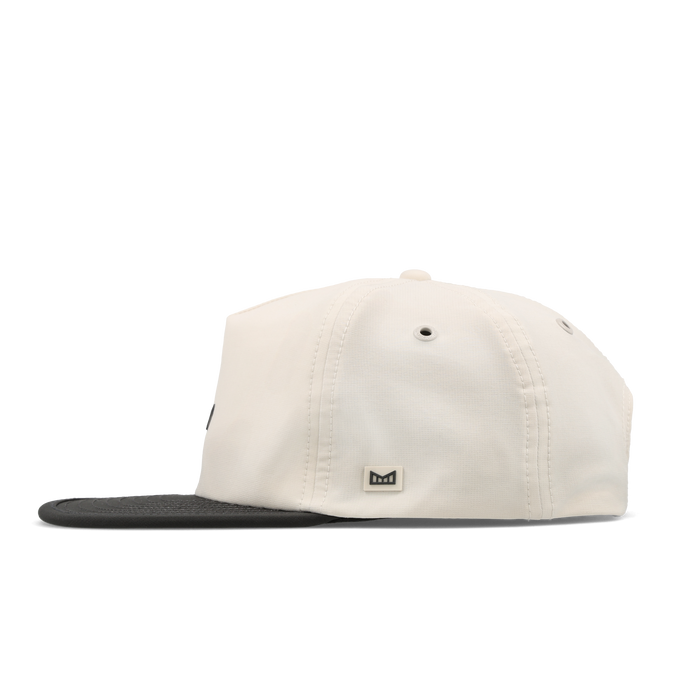 The side view of the melin Split Crushed Fit Eagle Hydro hat in moonbeam / pirate black