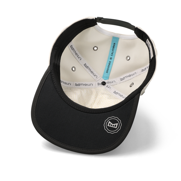 The inside view of the melin Split Crushed Fit Eagle Hydro hat in moonbeam / pirate black