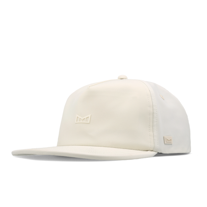 The angled view of the melin Split Crushed Fit Eagle Icon Hydro hat in egret