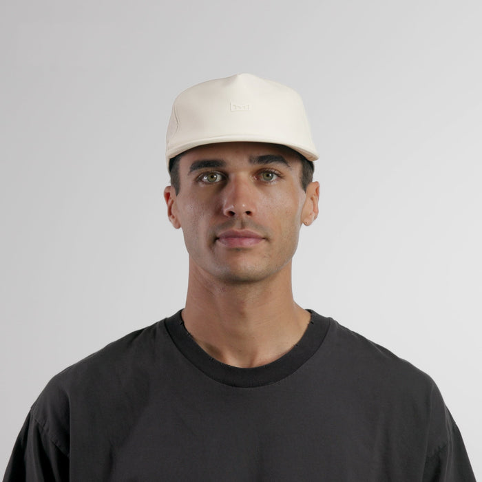 The model-image of the melin Split Crushed Fit Eagle Icon Hydro hat in egret