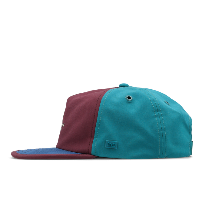 The side view of the melin Split Crushed Fit Eagle Links Clubhouse Hydro hat in grandeur