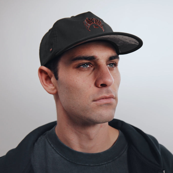 The model-image view of the melin Split Crushed Fit Eagle Mayhem Hydro hat in black
