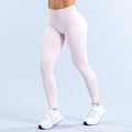 Light pink high-waist leggings with smooth, full-length fit