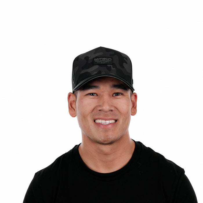 The model-image of the Melin Split Fit Odyssey Brick Hydro hat in Black Camo Midnight