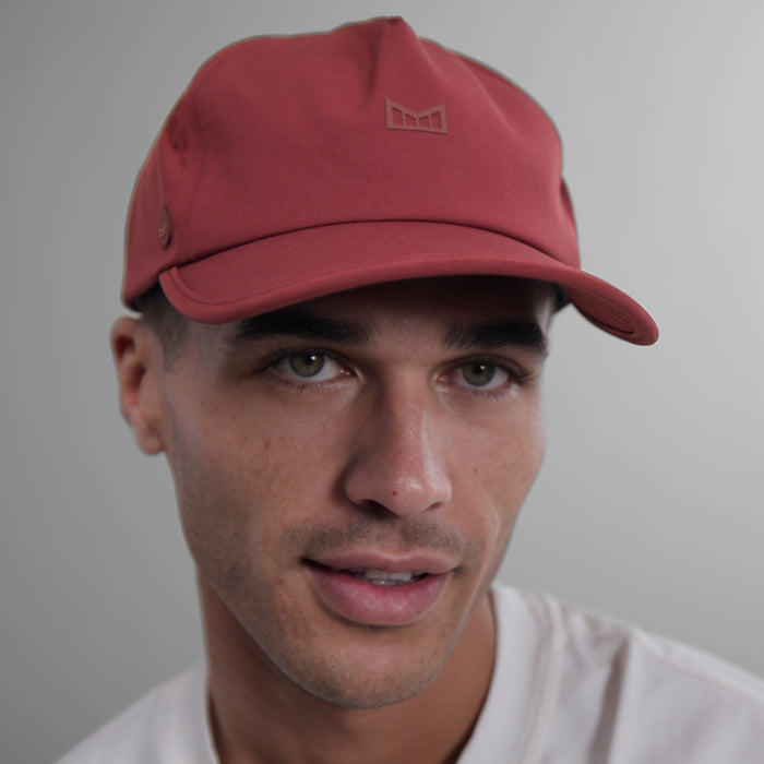 The model-image view of the melin Split Fit Odysea Hydro VO2 hat in Tawny Port