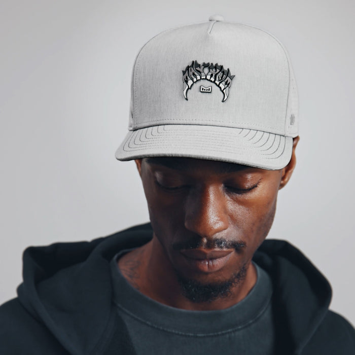 The model-image view of the melin Split Fit Odysea Mayhem Hydro hat in heather grey
