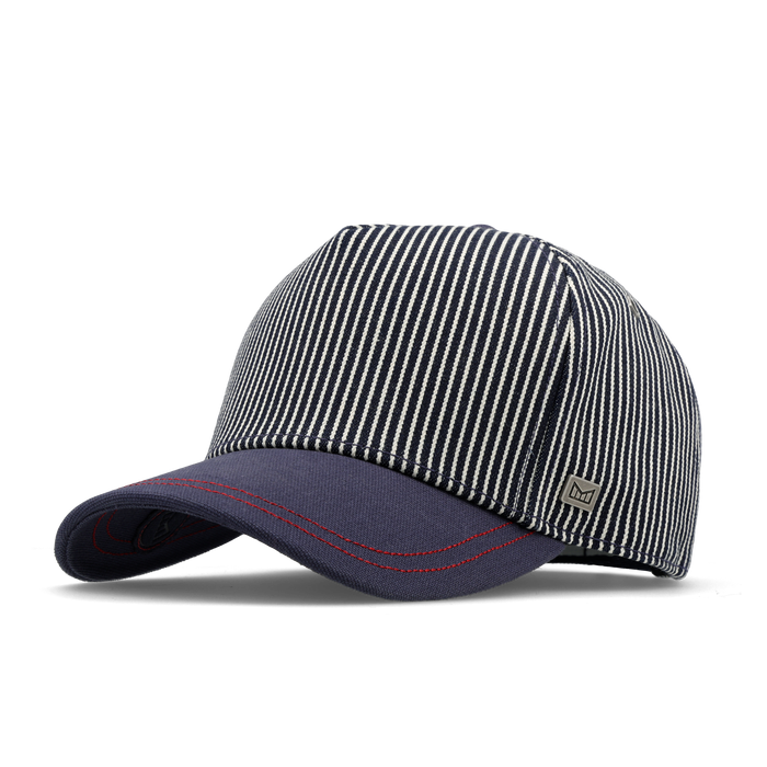 The angled view of the melin Split Fit Odysea Mill Union hat in hickory denim