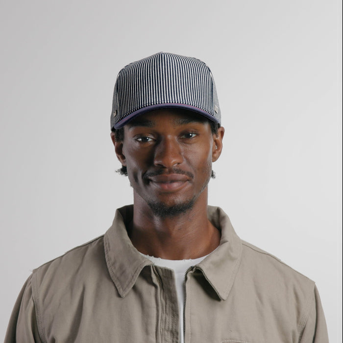 The model-image of the melin Split Fit Odysea Mill Union hat in hickory denim