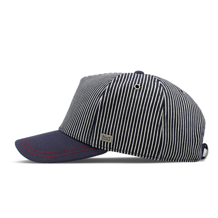 The side view of the melin Split Fit Odysea Mill Union hat in hickory denim