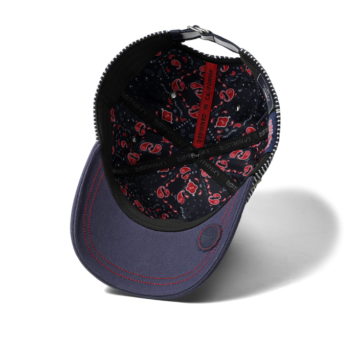 The inside view of the melin Split Fit Odysea Mill Union hat in hickory denim