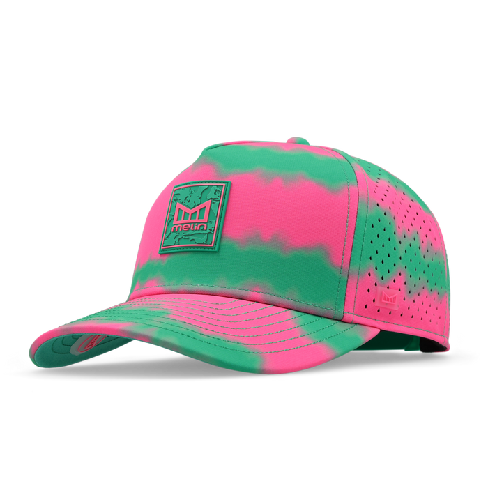 Neon pink and green tie-dye baseball cap with perforated mesh panels and branded patch on front.