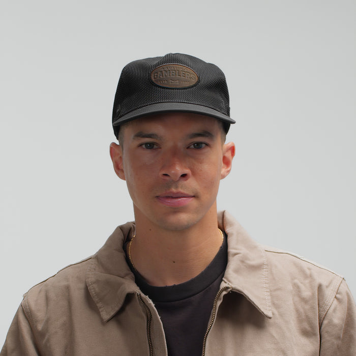 The model-image view of the melin Split Fit Odysea Retro Brand hat in Black