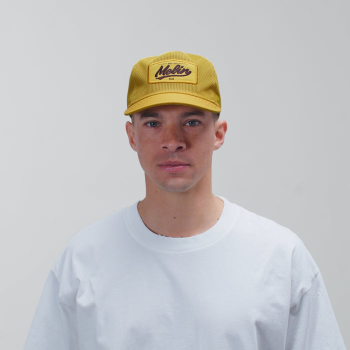 The model-image view of the melin Split Fit Odysea Retro hat in Golden