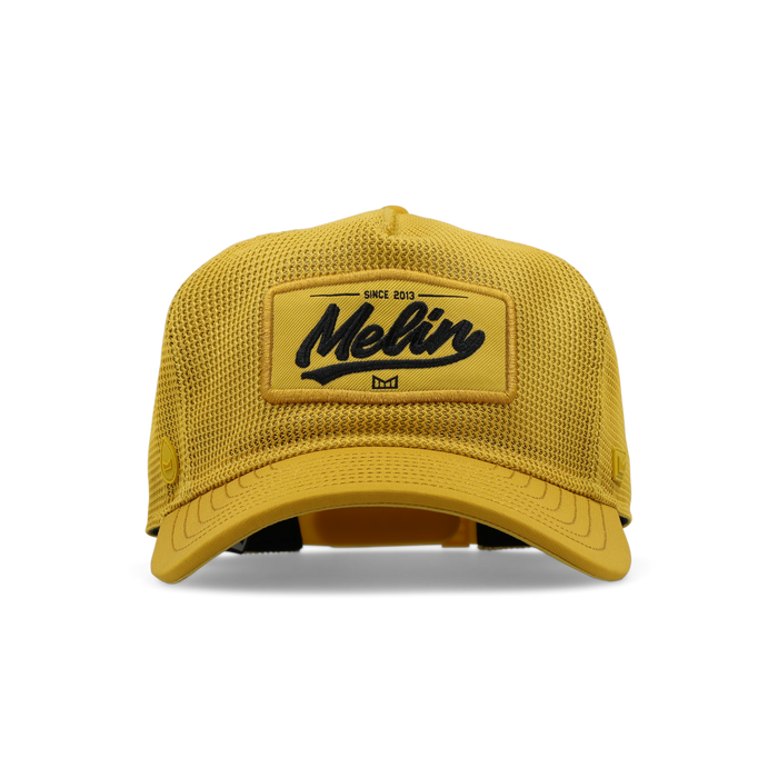 The frontal view of the melin Split Fit Odysea Retro Hydro hat in golden