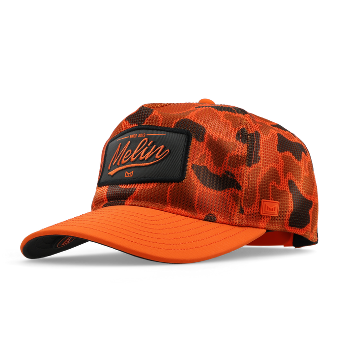 The angled view of the melin Split Fit Odysea Retro Hydro hat in safety orange