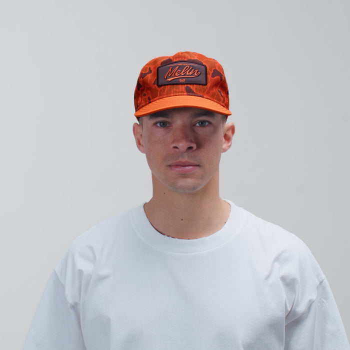 The model-image view of the melin Split Fit Odysea Retro hat in Safety Orange