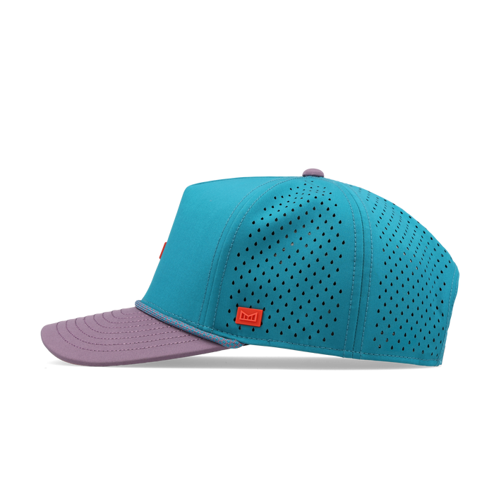 Turquoise and purple baseball cap with perforated mesh panels and red brand label on front.