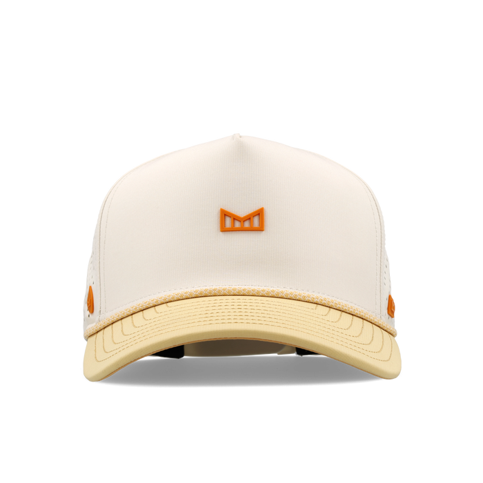 Cream and pale yellow baseball cap with orange bull icon emblem on front and side accents.