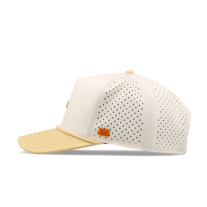 Cream and yellow baseball cap with perforated mesh panels and rope detailing on the bill.