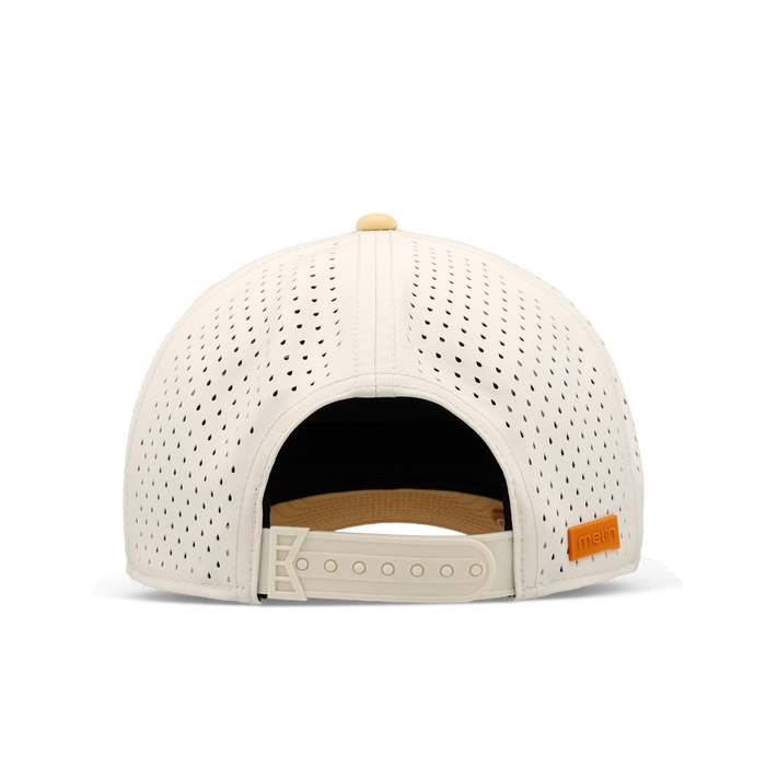 Cream perforated baseball cap with tan rope detail, adjustable back strap, and orange brand label.