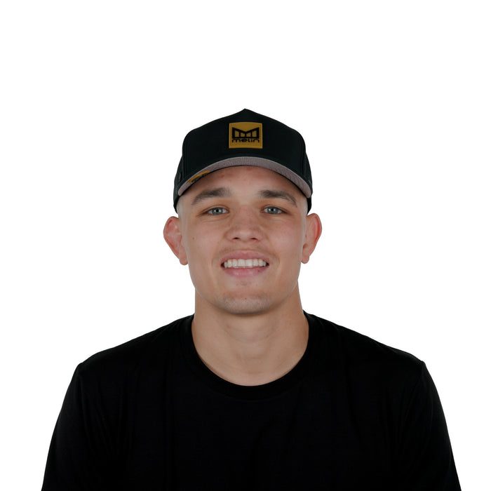 The model-image view of the Melin Split Fit Odysea Stacked Hydro hat in Black Gum