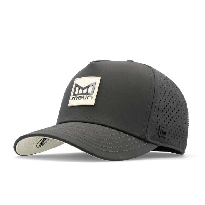 The angled view of the melin Split Fit Odysea Stacked Hydro hat in faded black
