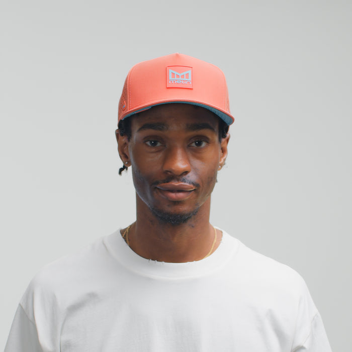 The model-image view of the melin Split Fit Odysea Stacked Hydro hat in Hot Coral