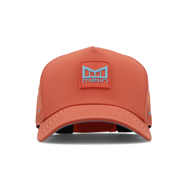Hot coral baseball cap with Melin logo patch on front and perforated side panels.