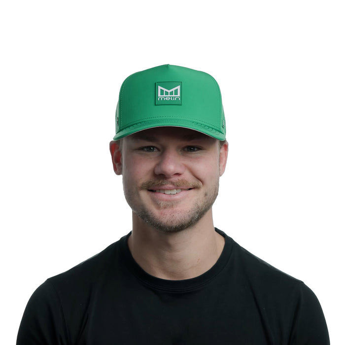 The model-image view of the Melin Split Fit Odysea Stacked Hydro hat in Kelly Green