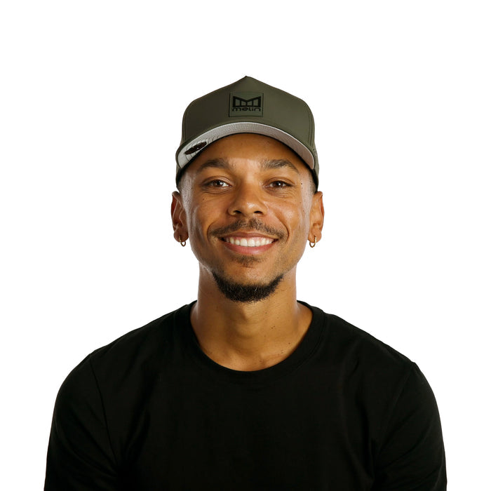The model-image of the Melin Split Fit Odysea Stacked Infinite Thermal hat in Pine Green