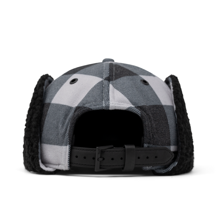 Black and white checkered baseball cap with black fuzzy ear flaps and adjustable back strap.