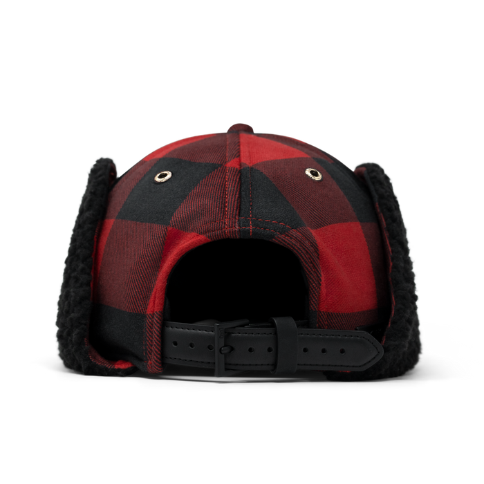 Red and black buffalo plaid thermal cap with black fleece ear flaps and adjustable back strap.