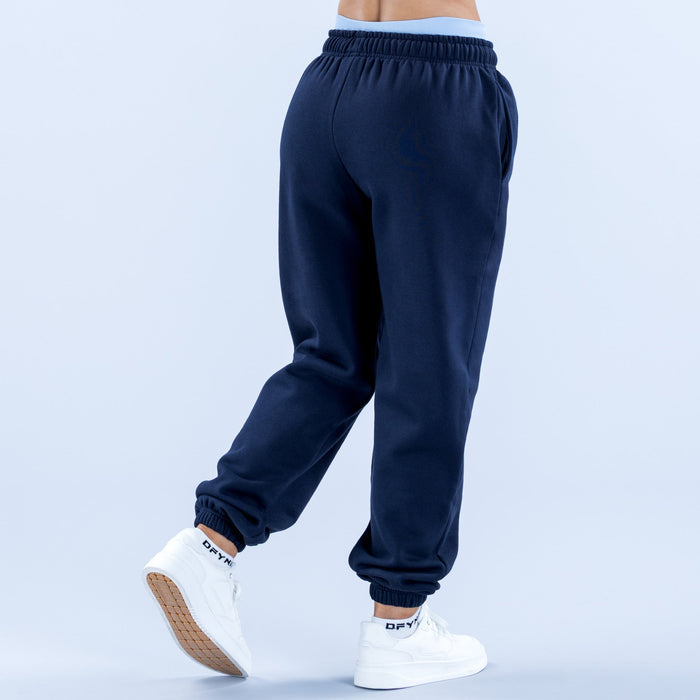 Navy sweatpants joggers with elastic waistband and ribbed cuffs, side view.