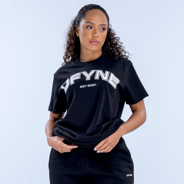 Black oversized graphic tee with large white DFYN logo and EST 2021