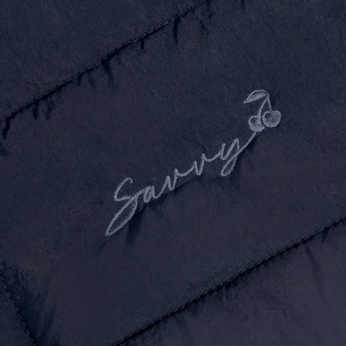 Embroidered script logo on dark quilted puffer bag panel